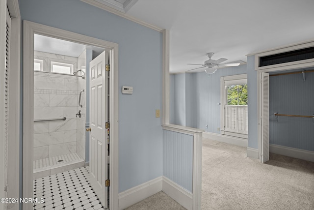 interior space with ceiling fan, a tile shower, and a healthy amount of sunlight