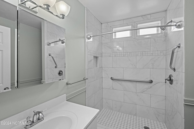 bathroom featuring vanity and tiled shower