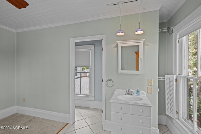 bathroom with ornamental molding, vanity, and tile patterned flooring