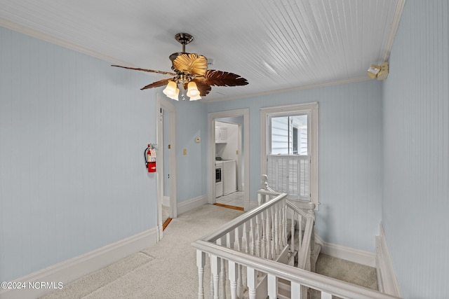 hallway with crown molding and light carpet