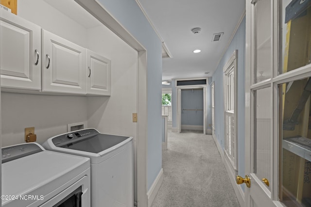 washroom with washer and clothes dryer, ornamental molding, cabinets, and light carpet