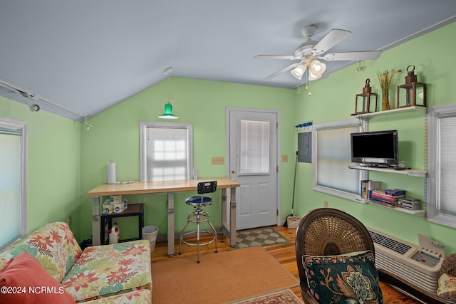 home office with light wood-type flooring, lofted ceiling, electric panel, and ceiling fan