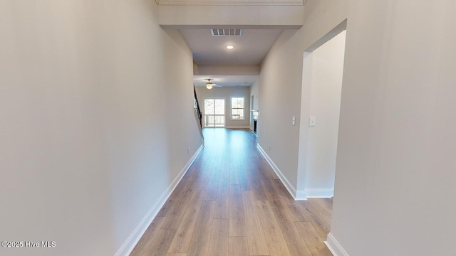 corridor with light hardwood / wood-style floors