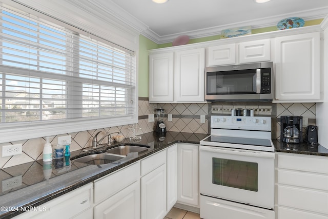 kitchen featuring sink, white cabinetry, dark stone countertops, and white range with electric cooktop