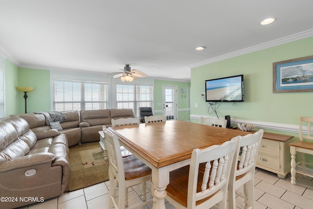 tiled dining room with crown molding and ceiling fan