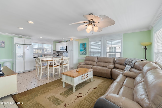 living room featuring ceiling fan, light tile patterned floors, and ornamental molding