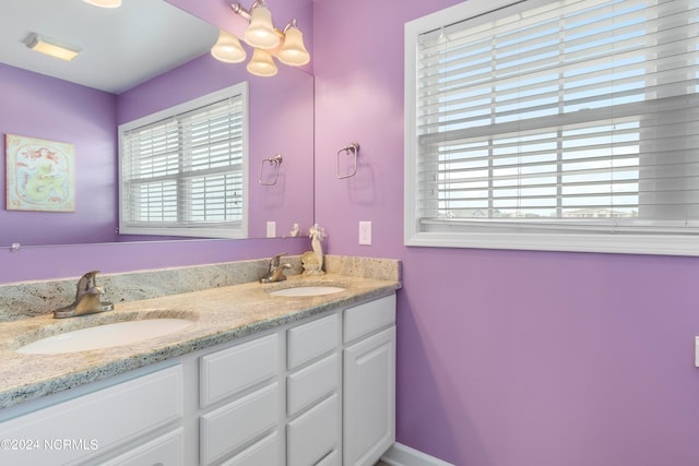 bathroom featuring a chandelier and vanity