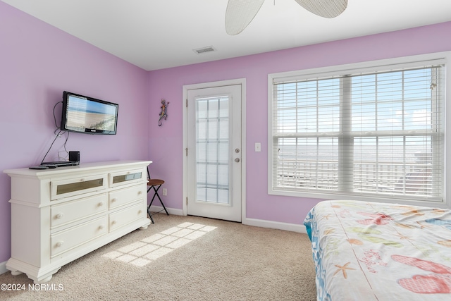 bedroom with ceiling fan, light colored carpet, and access to outside