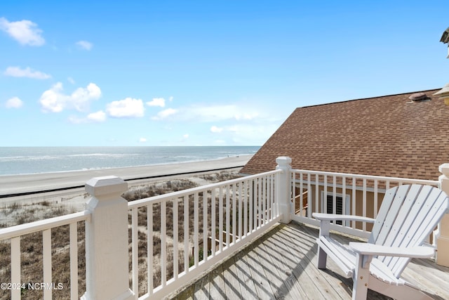 balcony featuring a water view and a beach view