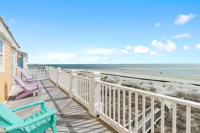 balcony with a view of the beach and a deck with water view