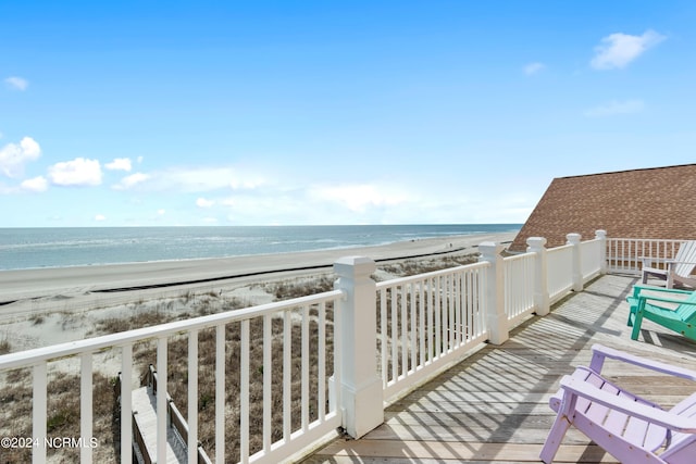 balcony featuring a beach view and a water view