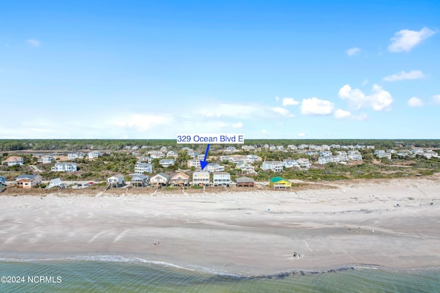 bird's eye view with a water view and a view of the beach