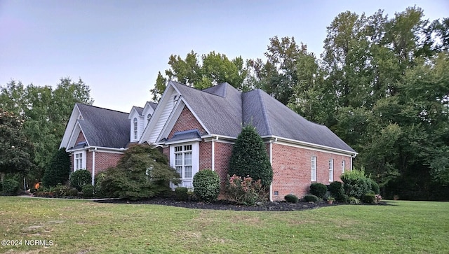 view of side of property featuring a yard