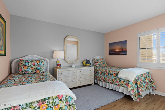 bedroom with dark hardwood / wood-style floors