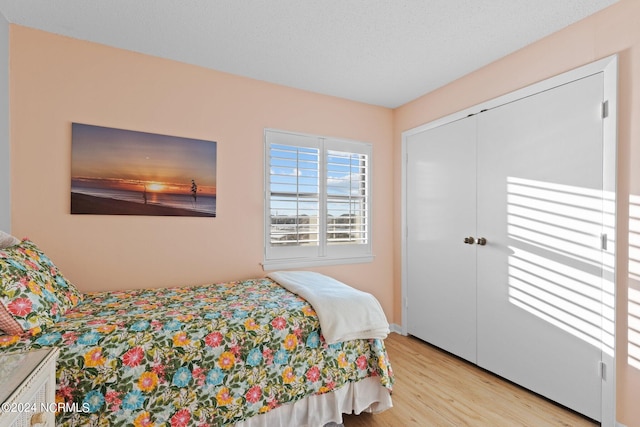 bedroom featuring light hardwood / wood-style flooring and a closet