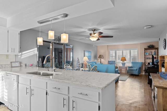 kitchen featuring white dishwasher, pendant lighting, ceiling fan, light hardwood / wood-style flooring, and white cabinetry