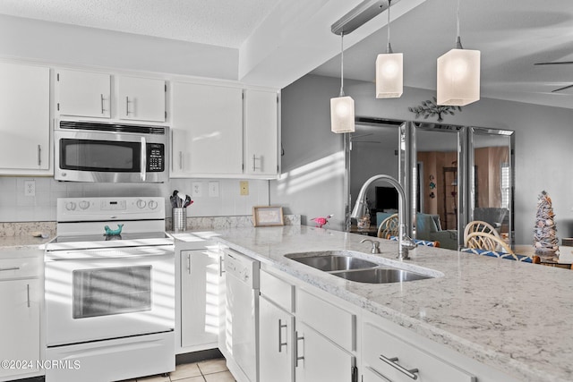 kitchen featuring white appliances, hanging light fixtures, light stone counters, and tasteful backsplash