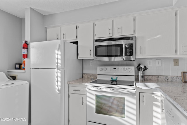 kitchen featuring tasteful backsplash, white appliances, white cabinetry, and washer / dryer