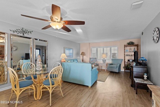 living room featuring light hardwood / wood-style floors and ceiling fan