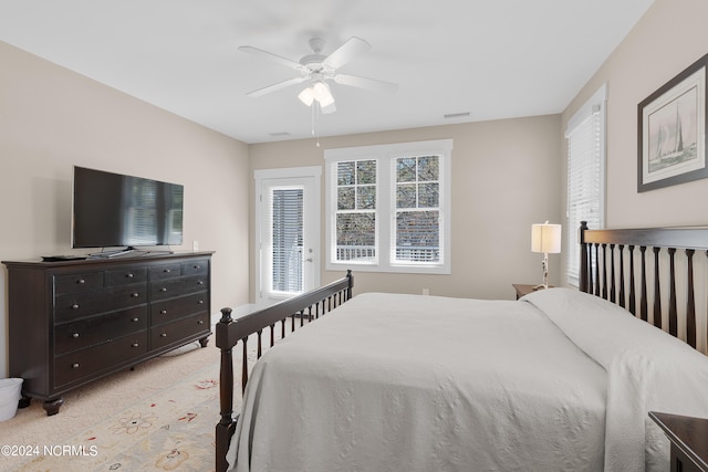 bedroom with ceiling fan and light carpet