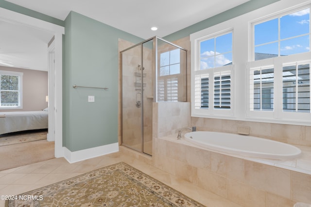 bathroom with tile flooring, plus walk in shower, and a wealth of natural light