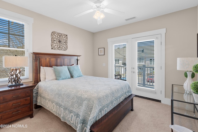 bedroom with multiple windows, light carpet, and ceiling fan