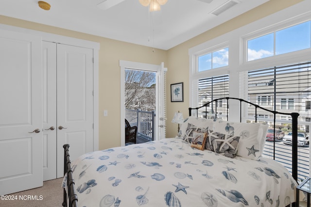 bedroom with ceiling fan, light carpet, access to outside, and a closet