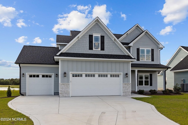 craftsman-style home with a garage and a front lawn