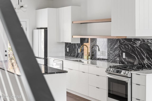 kitchen with decorative backsplash, white appliances, sink, dark hardwood / wood-style floors, and white cabinetry