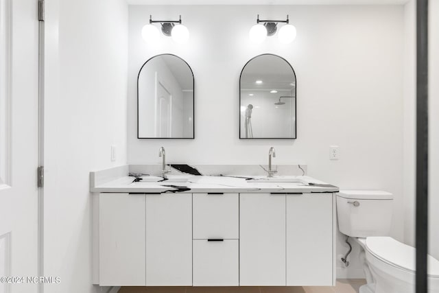 bathroom featuring vanity, toilet, and walk in shower