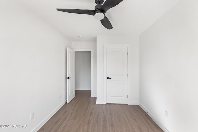 unfurnished bedroom featuring ceiling fan and light wood-type flooring