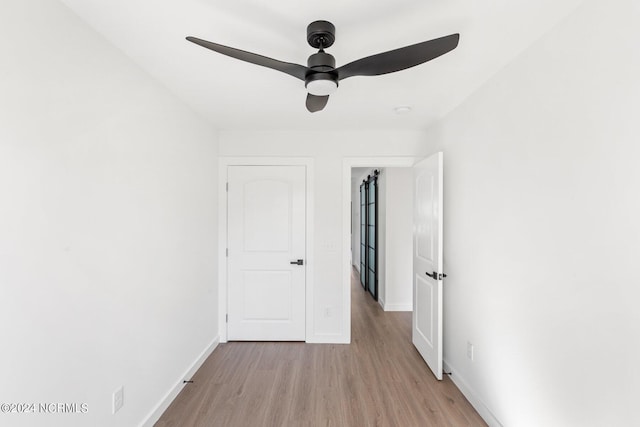 spare room with ceiling fan and light wood-type flooring