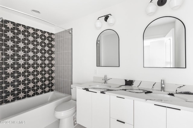 full bathroom with tiled shower / bath combo, toilet, and vanity