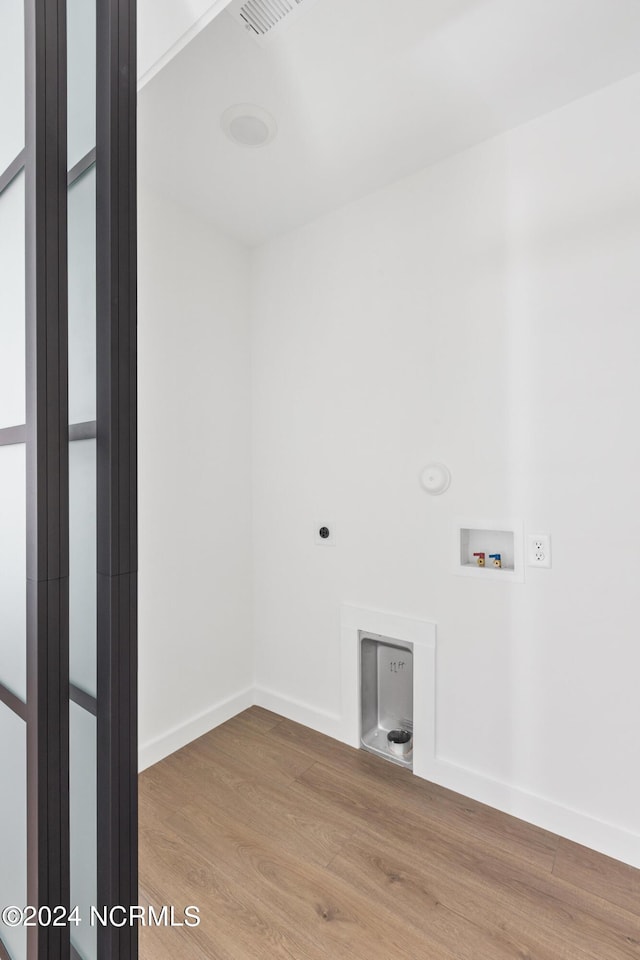 clothes washing area featuring electric dryer hookup, hookup for a washing machine, and wood-type flooring