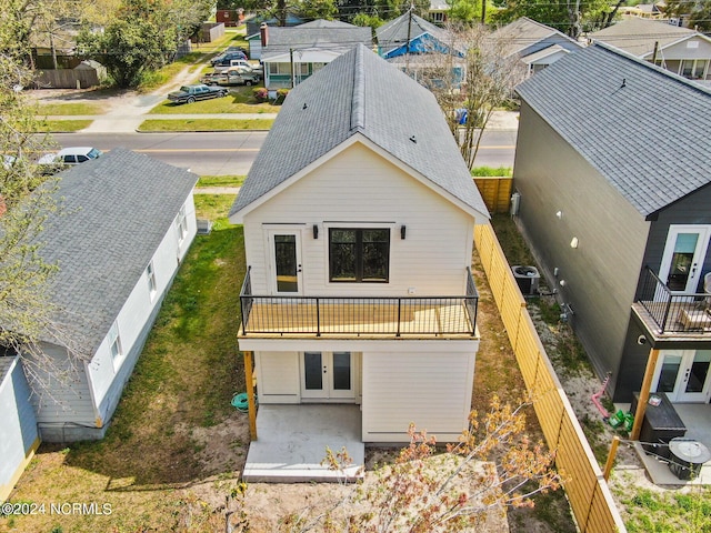 back of house with a balcony, central air condition unit, and french doors