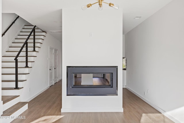 unfurnished living room featuring hardwood / wood-style floors