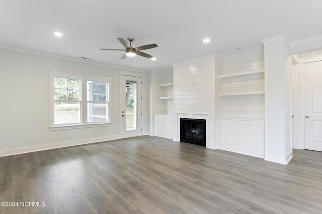 2058 Greenside Manor Dr, Ocean Isle Beach, NC 28469 - unfurnished living room featuring a ceiling fan, wood finished floors, a fireplace, baseboards, and ornamental molding