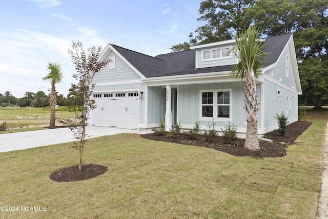 2058 Greenside Manor Dr, Ocean Isle Beach, NC 28469 - view of front of house featuring concrete driveway, a front lawn, board and batten siding, a porch, and a garage