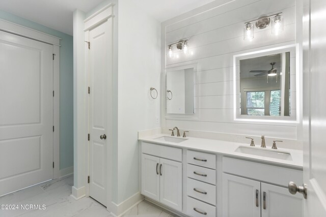 2058 Greenside Manor Dr, Ocean Isle Beach, NC 28469 - bathroom with baseboards, marble finish floor, a sink, and double vanity