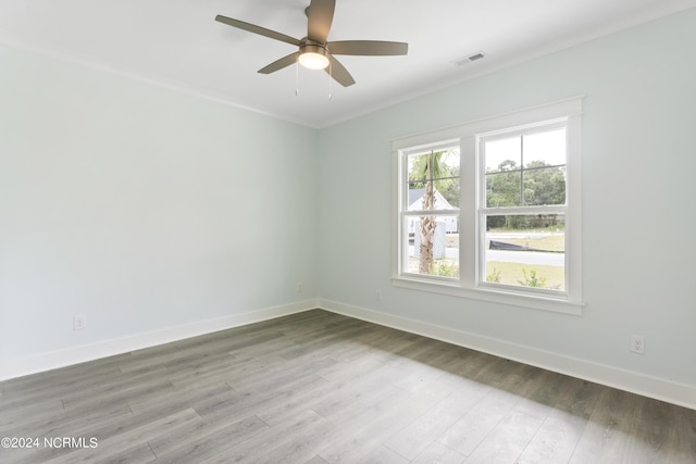 2058 Greenside Manor Dr, Ocean Isle Beach, NC 28469 - unfurnished room with wood finished floors, visible vents, ornamental molding, baseboards, and ceiling fan