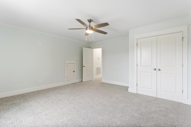 2058 Greenside Manor Dr, Ocean Isle Beach, NC 28469 - unfurnished bedroom featuring a closet, visible vents, baseboards, and light carpet