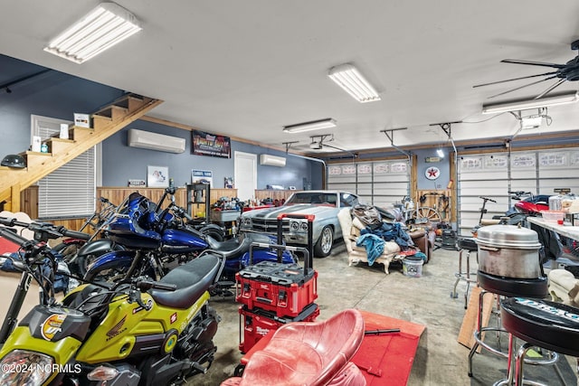 garage featuring a wall mounted AC and ceiling fan