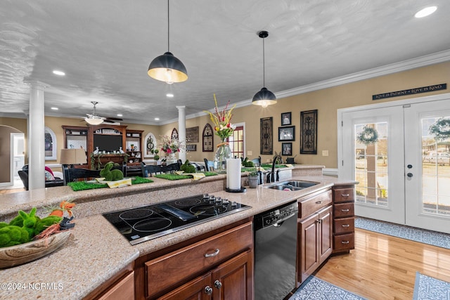 kitchen featuring pendant lighting, ceiling fan, light hardwood / wood-style flooring, black appliances, and ornate columns