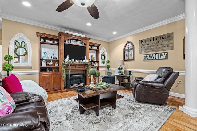 living room with ornamental molding, ornate columns, ceiling fan, and light wood-type flooring