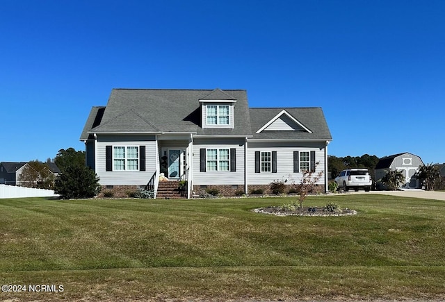 cape cod home featuring a front yard