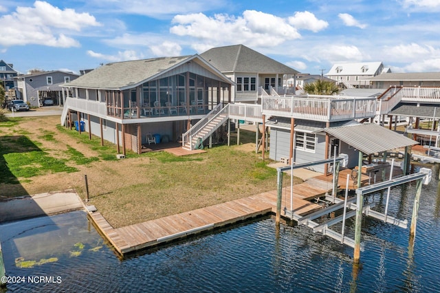 view of dock with a deck with water view and a lawn