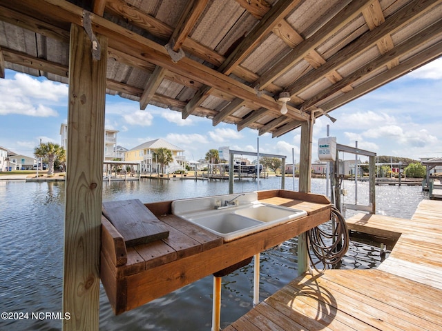 view of dock featuring a water view and sink