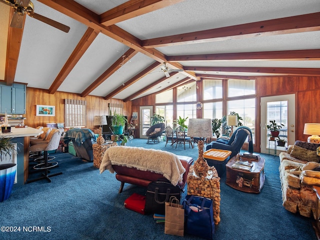 interior space with carpet flooring, ceiling fan, lofted ceiling with beams, and a textured ceiling