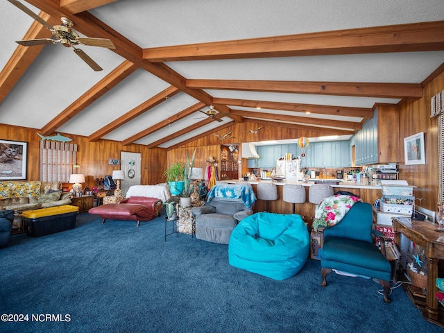 carpeted living room featuring vaulted ceiling with beams, ceiling fan, and wooden walls