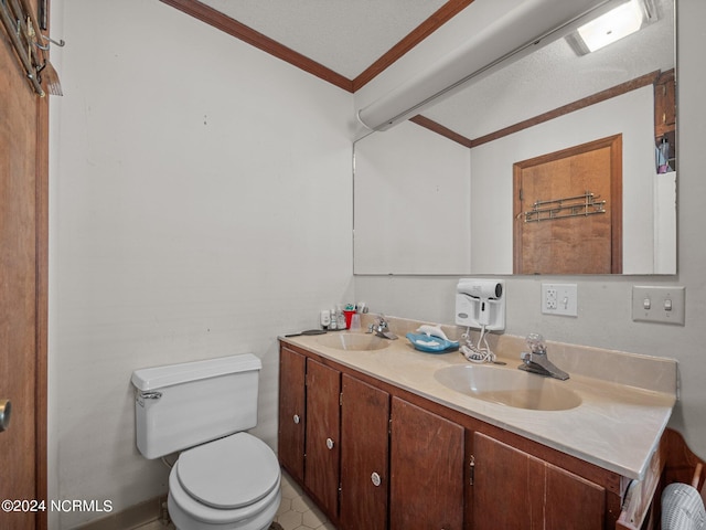 bathroom featuring toilet, vanity, a textured ceiling, and ornamental molding